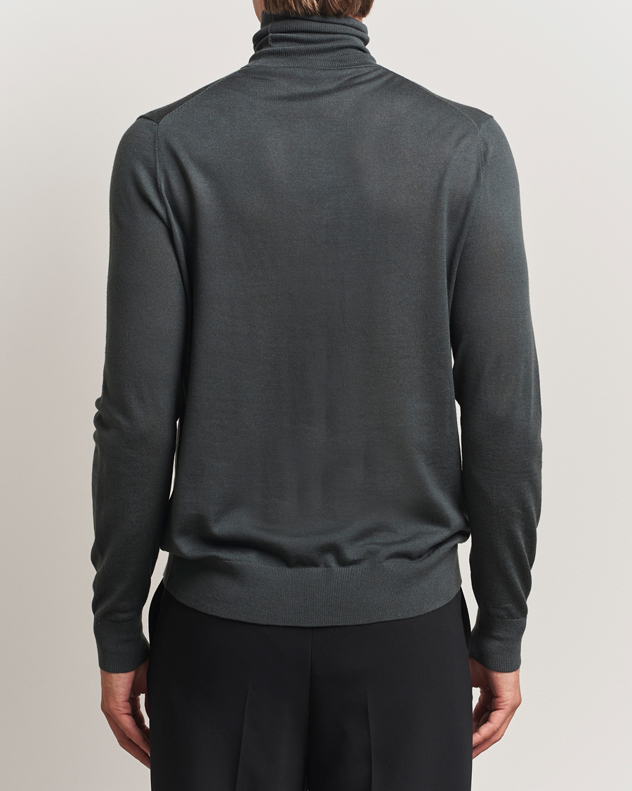 Uomini | Maglieria | Tiger of Sweden | Nevile Extra Fine Merino Polo Midnight Green